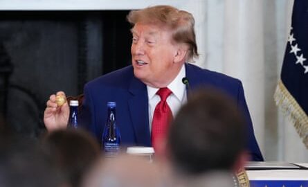 Donald Trump holds up a gold replica of a deep sea nodule given to him at a mining industry event earlier this month.