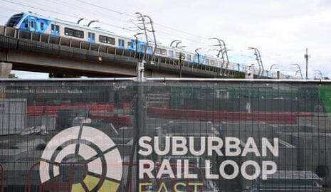 A train approaches Clayton Metro station passing construction work for the Suburban Rail Loop East at Clayton in Melbourne