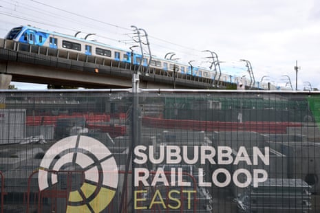 A train approaches Clayton Metro station passing construction work for the Suburban Rail Loop East at Clayton in Melbourne