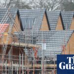 Homes under construction surrounded by scaffolding