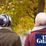 Two Muslim women walking in a park