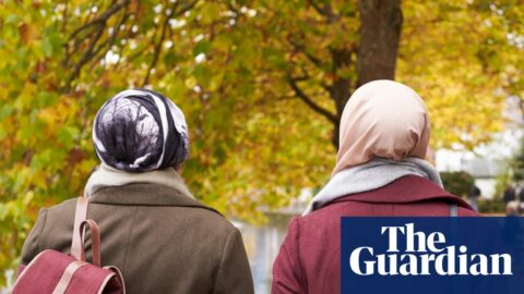 Two Muslim women walking in a park
