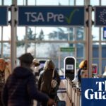 Travelers walk through a TSA security checkpoint