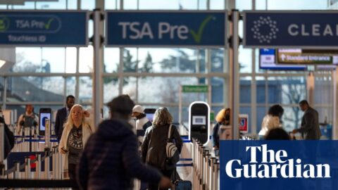 Travelers walk through a TSA security checkpoint