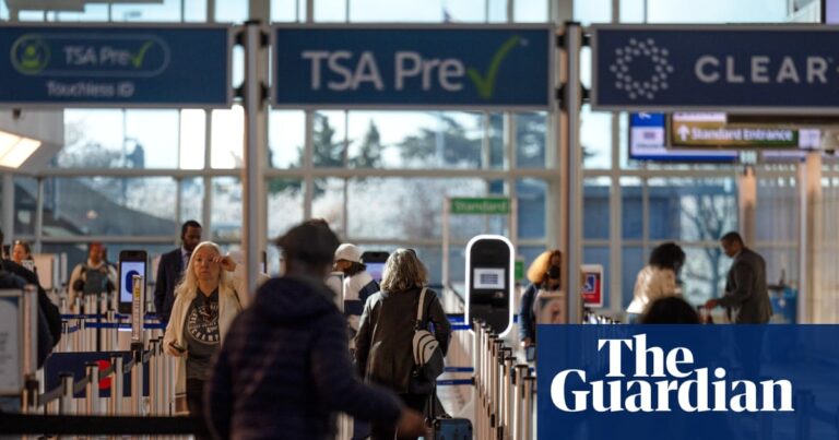 Travelers walk through a TSA security checkpoint
