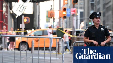 A police officer standing near two barricades