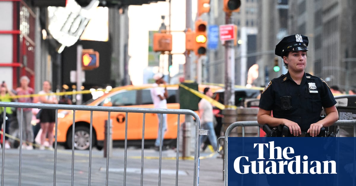 A police officer standing near two barricades