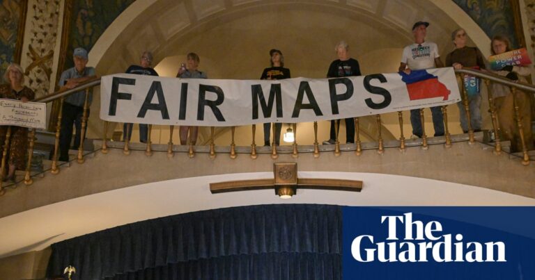 Activists display signs during a press conference inside the rotunda of the Missouri State Capitol.