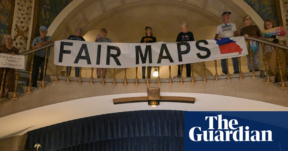Activists display signs during a press conference inside the rotunda of the Missouri State Capitol.