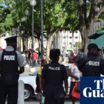 Police walking down a street in Port of Spain