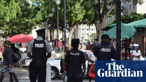 Police walking down a street in Port of Spain
