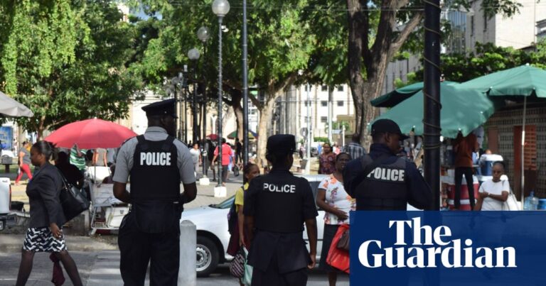 Police walking down a street in Port of Spain