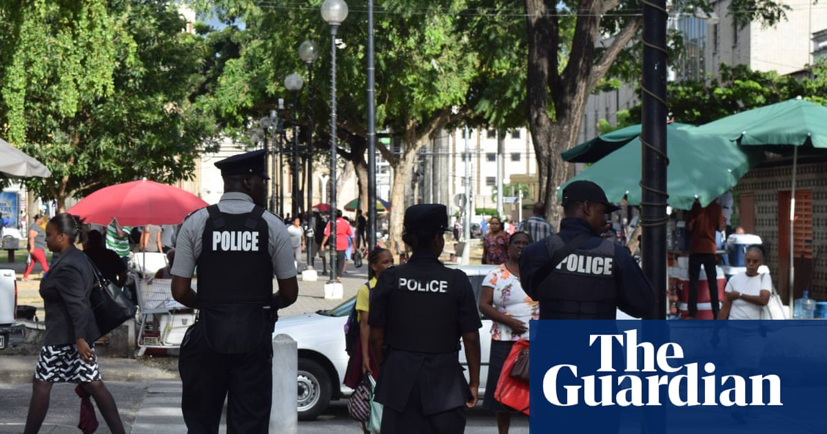 Police walking down a street in Port of Spain