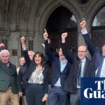 Colin Bermingham, Alex Pabon and supporters raise fists in celebration outside the Royal Courts of Justice