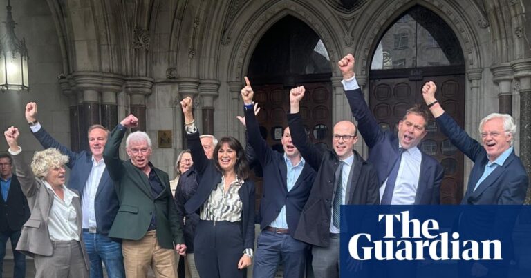 Colin Bermingham, Alex Pabon and supporters raise fists in celebration outside the Royal Courts of Justice