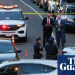 Cars and people at scene of shooting