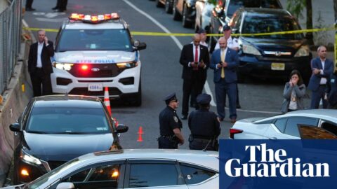 Cars and people at scene of shooting