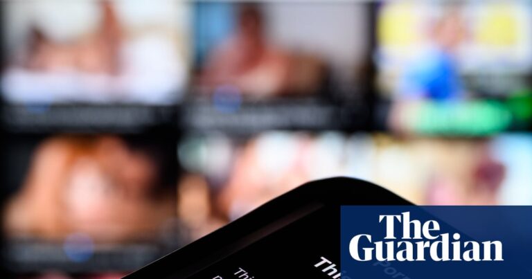 A smartphone screen displays a Pornhub age-restriction warning in a close-up with a blurred background