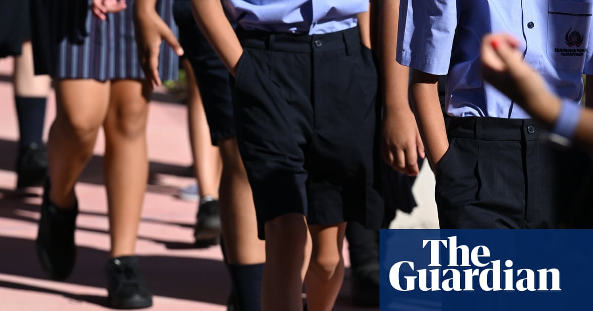 NSW schoolchildren in uniform walk in a line on the first day of term