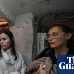 Residents and rescuers take a shelter in a basement of an apartment building in Kharkiv during a threat of another Russian drone strike.