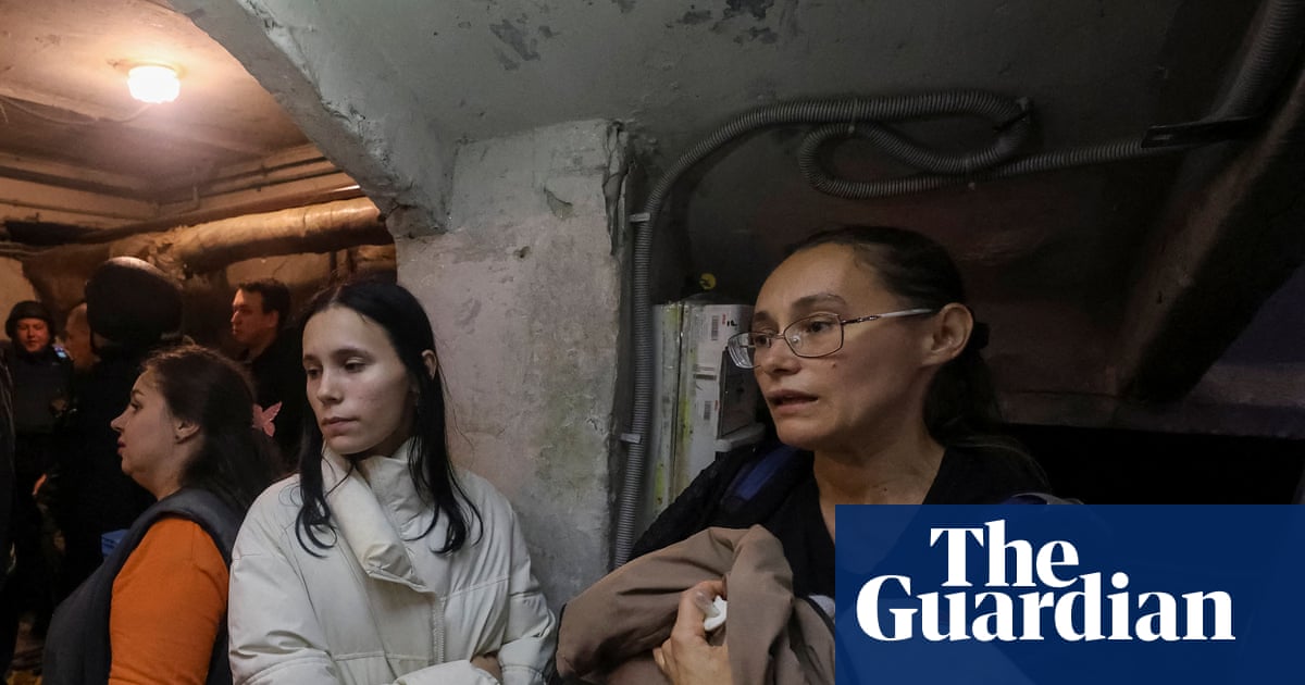 Residents and rescuers take a shelter in a basement of an apartment building in Kharkiv during a threat of another Russian drone strike.