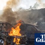 Cars burning after a Russian strike on a residential neighbourhood in Kharkiv
