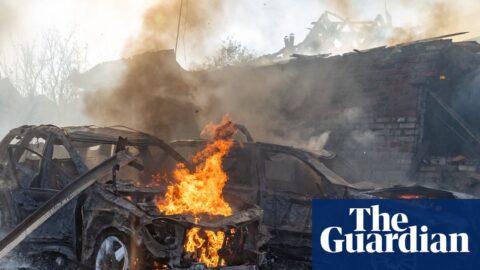 Cars burning after a Russian strike on a residential neighbourhood in Kharkiv