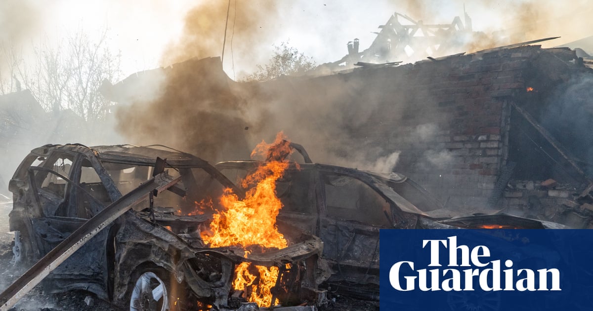 Cars burning after a Russian strike on a residential neighbourhood in Kharkiv