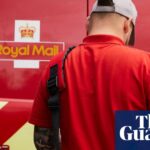 A Royal Mail worker with a bag, standing behind a Royal Mail van
