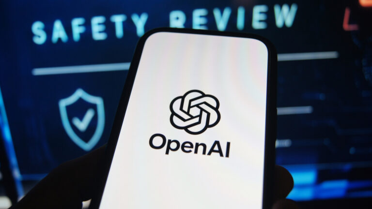 OpenAI logo is shown on a smartphone in front of the words 'safety review'